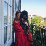 Delia is modelling her mother's coats: This is a Burberry red coat bought in the 1990s.